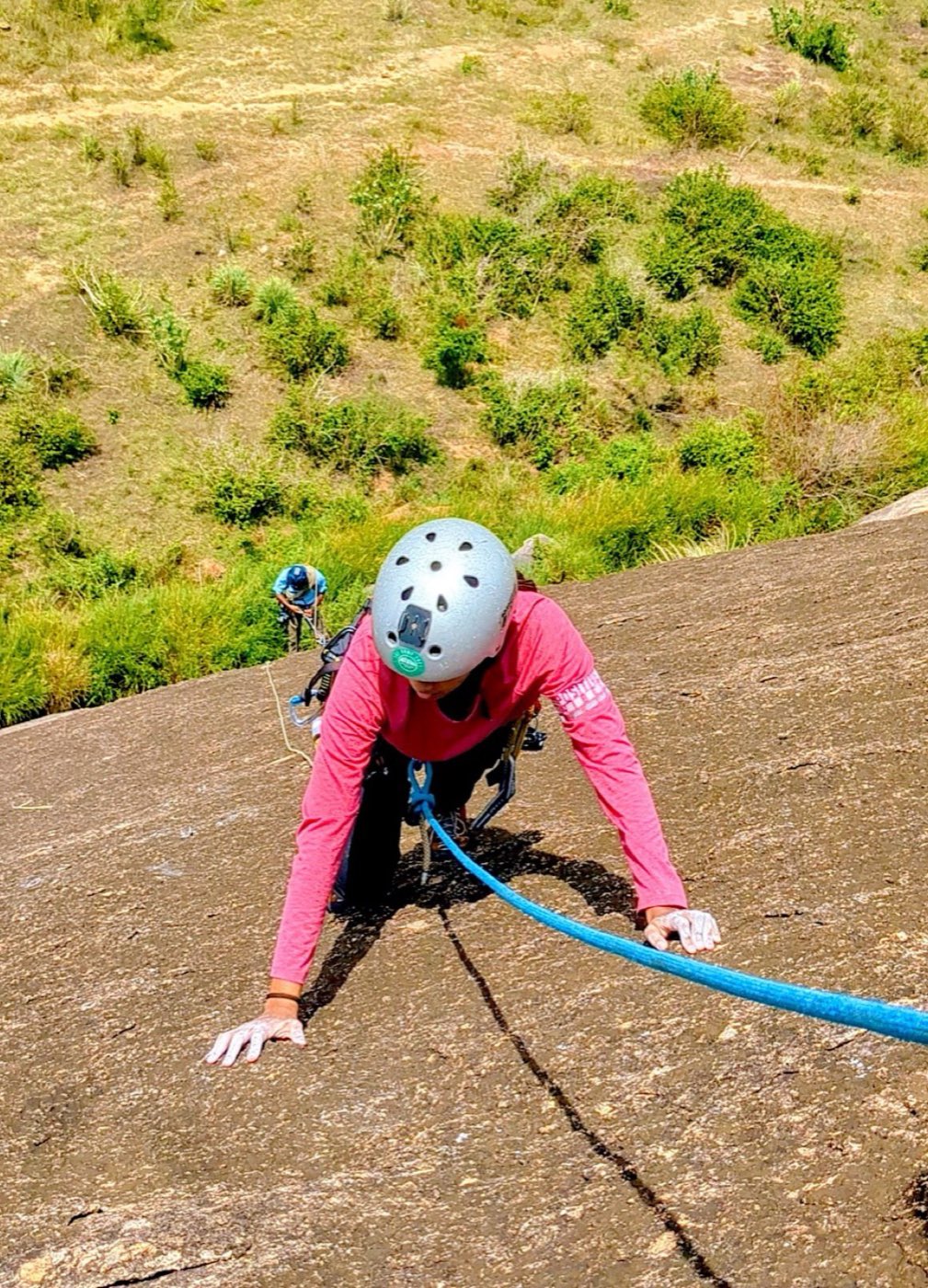 A student rock climbing with a rope