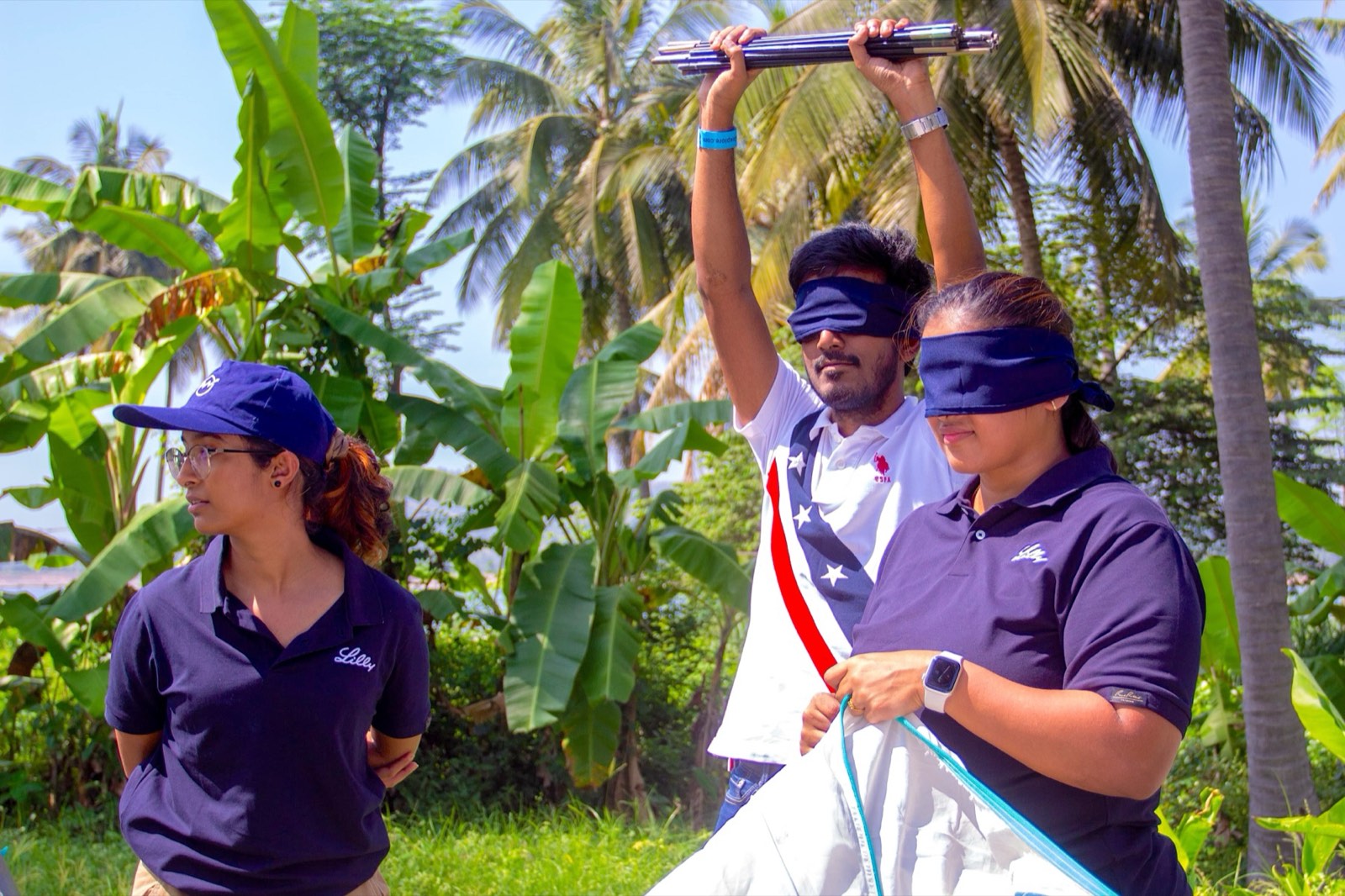 Blindfolded colleagues working out a tent together
