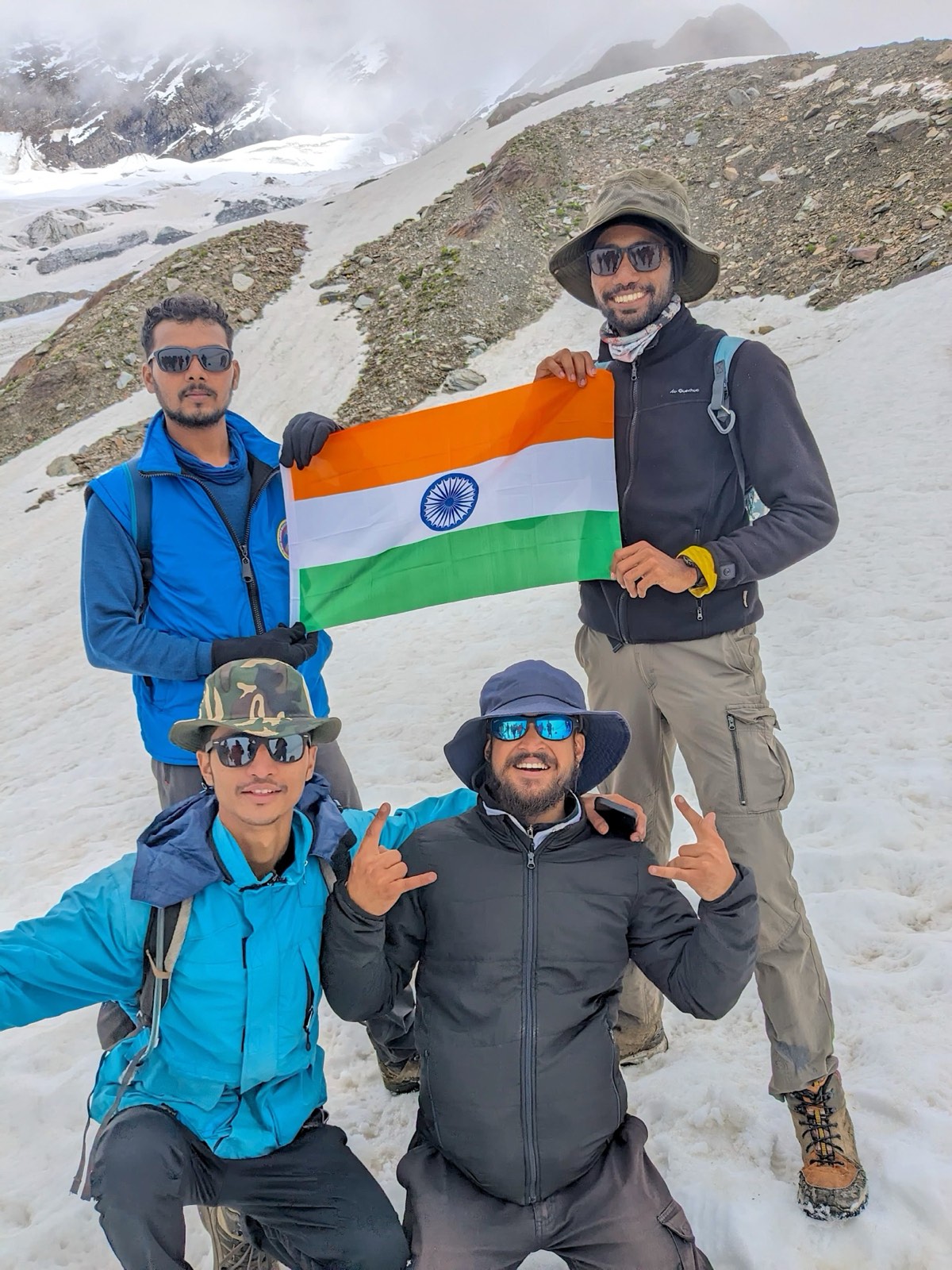 The team holding the Indian flag on a snow summit
